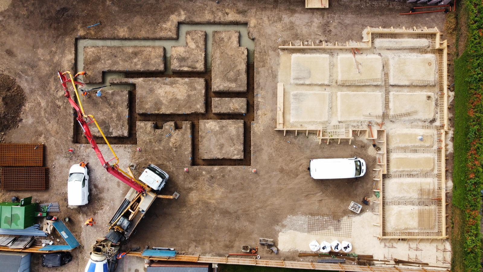 Aerial view of foundation trenches and concrete pump pouring footings on a Norfolk site | groundworks in King's Lynn by Humphries Construction